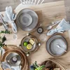 A table setting with plates, napkins, cutlery, and decorative elements. Produktbild-Vorschau