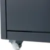 A close-up view of the bottom corner of a gray roll container, showing a white caster wheel. Podgląd zdjęcia produktu