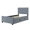A gray upholstered bed frame with a headboard and a pull-out trundle bed is shown against a white background. Náhled obrázku produktu