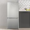 A silver refrigerator is shown in a kitchen setting next to dark gray cabinets and a white tiled backsplash. Produktbild-Vorschau