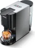 A close-up of a silver and black espresso machine brewing coffee into a clear glass mug. Produktbild-Vorschau