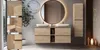 A modern bathroom vanity with a large round mirror and a tall cabinet, illuminated by soft lighting. Náhled obrázku produktu