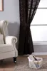 A living room scene with a wingback chair, a patterned curtain, and a basket of magazines. Produktbild-Vorschau