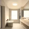 A modern, minimalist bathroom with a freestanding bathtub and a double vanity. Produktbild-Vorschau