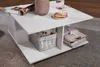 A white coffee table with items on and under it, placed on a rug. Voir les images du produit