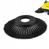 A close-up of a black sweeping brush head with a blurred yellow cleaning machine in the background. Produktbild-Vorschau
