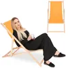 A woman is sitting in a deck chair holding a mug. Produktbild-Vorschau