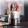 A hand is shown rotating a coffee distributor tool on top of a portafilter, which is part of an espresso machine. Náhľad obrázku produktu
