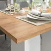 A close-up view of a dining table set for a meal, with place settings and drinks. Voir les images du produit