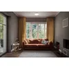 A living room with a sofa, curtains, and a large window. Produktbild-Vorschau