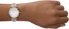 A woman's wrist wearing a silver and rose gold watch. Voir les images du produit