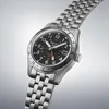 A close-up studio shot of a Seiko 5 GMT watch with a black dial and stainless steel bracelet, set against a light gray background. Produktbild-Vorschau