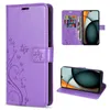 A collage of images showing a purple flip phone case with a floral and butterfly design. One image shows the case open with cards and money inside, and a phone inserted. Another image shows the phone case in a stand-up position with a phone inside. Produktbild-Vorschau