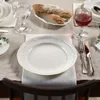 A table setting with a plate, cutlery, and bread. Náhľad obrázku produktu