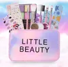 A makeup set for children, including a cosmetic bag, eyeshadow palette, brushes, glitter, and nail file, set against a soft, dreamy background. Produktbild-Vorschau