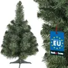 A small artificial Christmas tree is shown on a white background, with a close-up of its branches and a tag on the right side. Produktbild-Vorschau