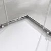 A close-up view of the corner of a shower enclosure, showing the metal frame and glass panels. Produktbild-Vorschau