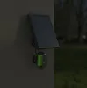 A solar-powered outdoor security camera is mounted on a wall. Podgląd zdjęcia produktu