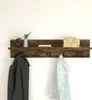 A wall-mounted coat rack with a shelf, displaying decorative items and hanging clothing. Produktbild-Vorschau