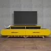 A modern yellow TV stand with a television on top, set against a textured gray wall and a wooden floor. Produktbild-Vorschau