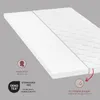 A close-up, angled view of a white mattress topper, showing its layered construction and quilted top surface. Produktbild-Vorschau