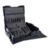 An open black tool case with various compartments and tools inside, placed on a black textured mat. Produktbild-Vorschau