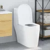 A white toilet in a bathroom setting, next to a wooden cabinet and a shelf unit with towels. Podgląd zdjęcia produktu