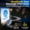A man looking at an illuminated sign at night. Produktbild-Vorschau