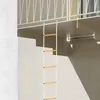 A fire escape ladder is attached to a railing above a concrete staircase. Podgląd zdjęcia produktu