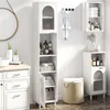 A bathroom with white storage cabinets and a round mirror. Produktbild-Vorschau