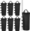 A set of six black sandbags for a canopy or umbrella, arranged in two rows of three, with an additional sandbag shown attached to a white pole on the right side of the image. Produktbild-Vorschau