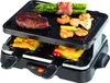 A raclette grill with food cooking on it. Produktbild-Vorschau