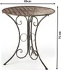 A decorative metal garden table with intricate cutouts. Produktbild-Vorschau