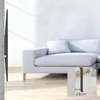 A TV wall mount is shown attached to a wall, with a sofa in the background. Voir les images du produit