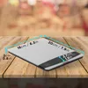 A digital scale on a wooden table. Produktbild-Vorschau