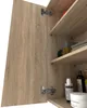 A close-up view of an open bathroom cabinet with wooden doors and shelves, showing rolled towels and toiletries. Voir les images du produit