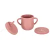 A pink silicone baby cup with handles, a straw lid, and a snack lid, all on a white background. Voir les images du produit