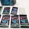 A collection of Magic: The Gathering Duskmourn: House of Horror play booster packs and a Nightmare Bundle are displayed on a white surface, with a decorative television-shaped box in the background. Produktbild-Vorschau
