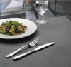 A salad and a glass of water are set on a table with cutlery. Produktbild-Vorschau