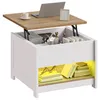 A lift-top coffee table with storage, displaying a laptop, cup, camera, and books. Produktbild-Vorschau