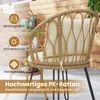 A close-up view of a rattan chair with a cushion, set outdoors with a wooden background and a small table with fruit. Podgląd zdjęcia produktu