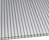 A close-up, angled view of a clear polycarbonate sheet with internal vertical channels, showing its ribbed texture and construction. Anteprima dell’immagine prodotto
