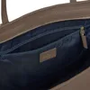 Close-up view of the interior of a brown leather bag, showing a zippered pocket and a brand label. Anteprima dell’immagine prodotto