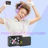 A woman is happily dancing while listening to music on a portable MP3 player. Produktbild-Vorschau