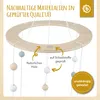 A wooden mobile with hanging wooden beads and a circular frame. Produktbild-Vorschau