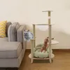 Two cats are playing on a multi-level cat tree next to a sofa. Náhled obrázku produktu