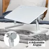A white laptop table is set up on a bed with a blanket. Produktbild-Vorschau