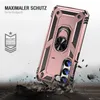 A rose gold phone case with a ring holder is shown in a dynamic pose, with debris flying around it, suggesting durability and protection. Produktbild-Vorschau