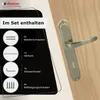 A door handle set is displayed with its included accessories, presented on a wooden surface. Produktbild-Vorschau