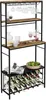 A tall, multi-tiered metal wine rack with wooden shelves, holding wine bottles, glasses, and decorative items. Podgląd zdjęcia produktu